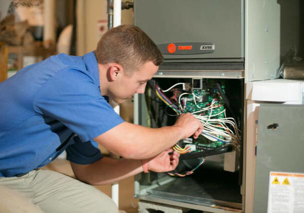 HVAC technician checking wiring